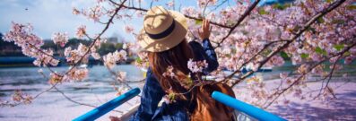 Woman in boat with cherry blossoms