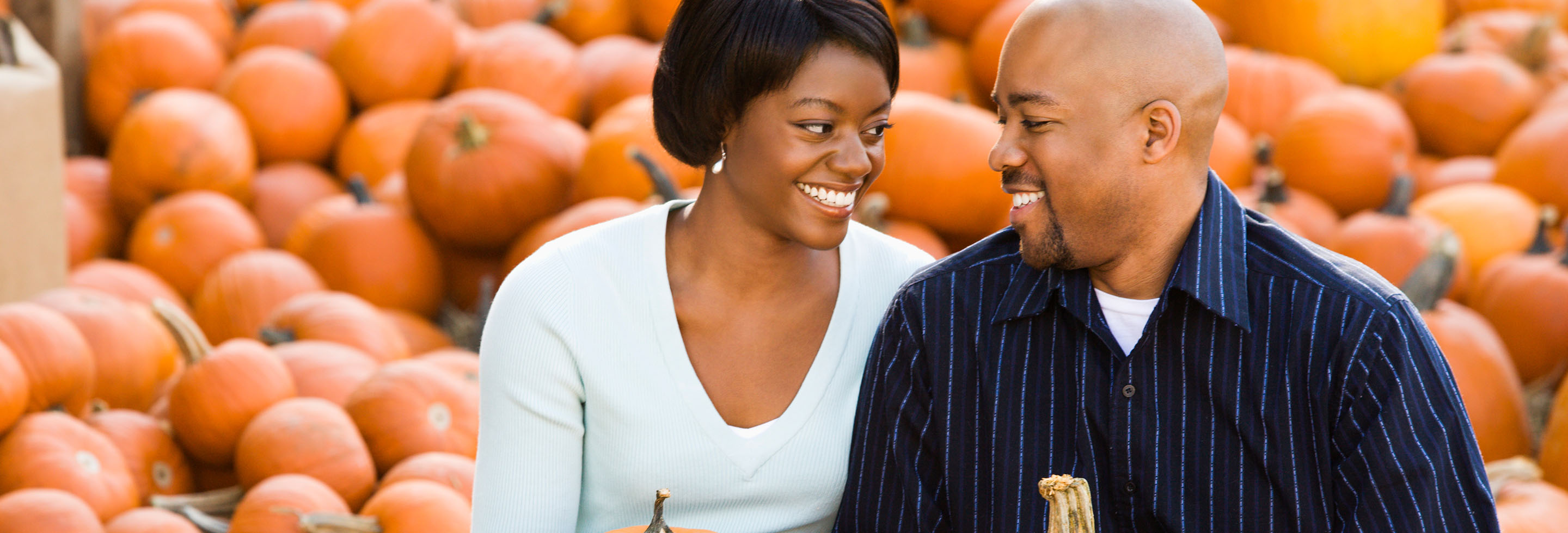 couple with pumpkins