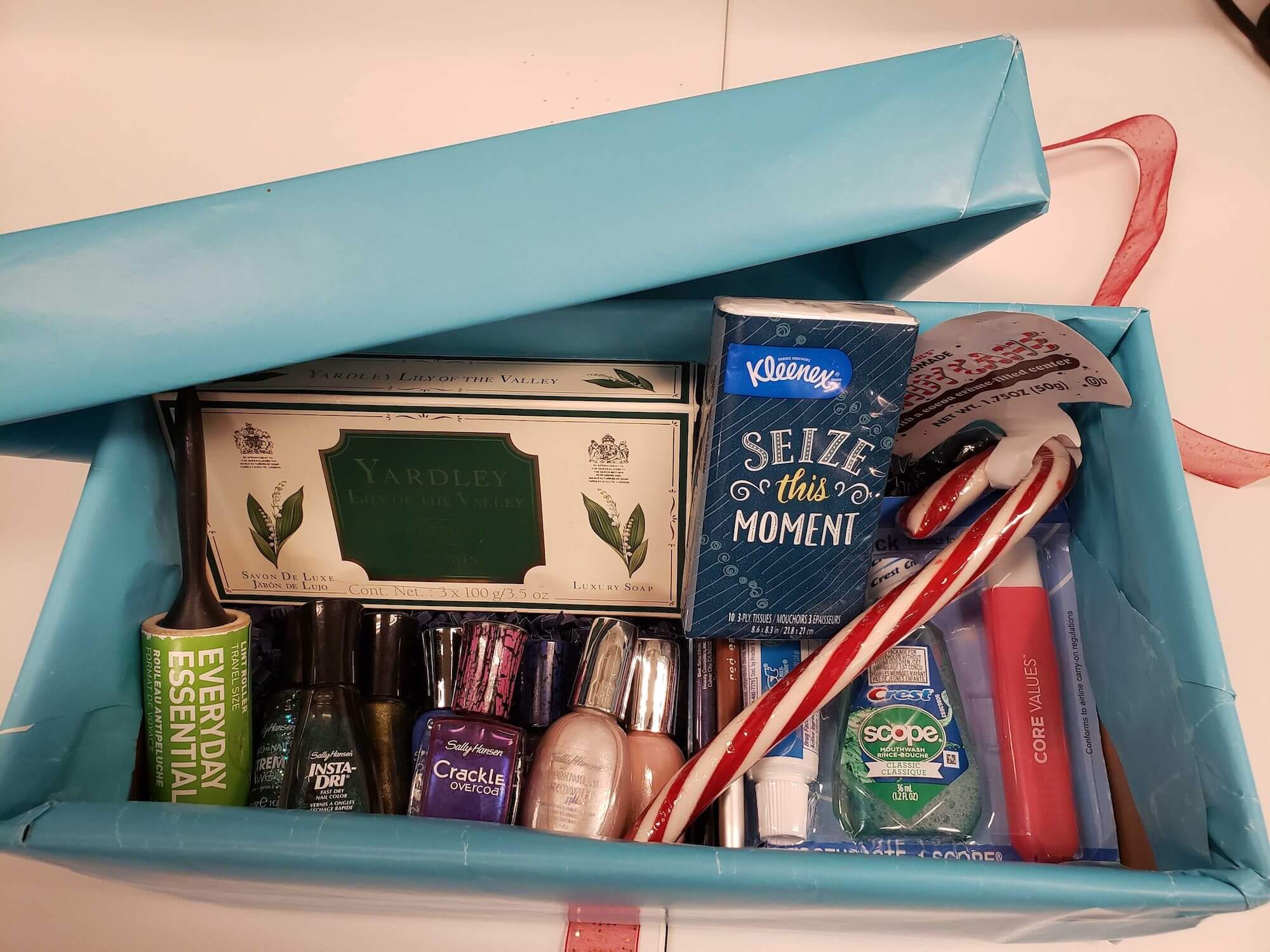 Shoe box with nail polish, tissues, and a candy cane